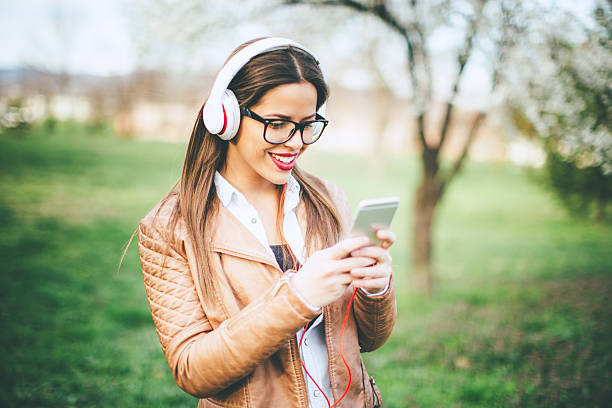 istock Woman with phone and headphones 514919508