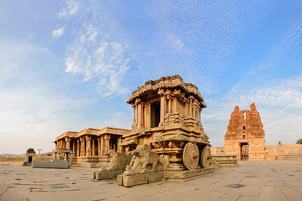 Stone chariot in courtyard of Vittala Temple at sunset in Hampi, Karnataka, India