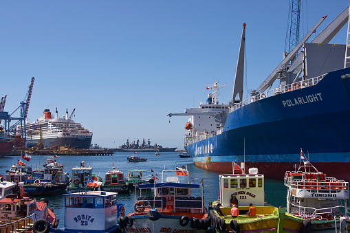 Valparaiso, Сhile - February 17, 2016: Cargo ship, ocean liner, warships and a selection of smaller craft in the busy harbour of the UNESCO World Heritage port city of Valparaiso in Chile.