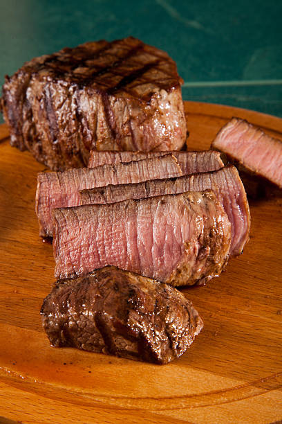 istock Beef steak cooked to medium rare on wooden background 514922698