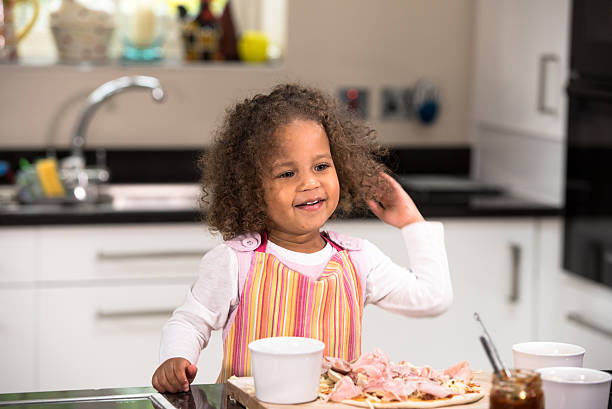 istock Happy Biracial Girl Making Pizza 514925890