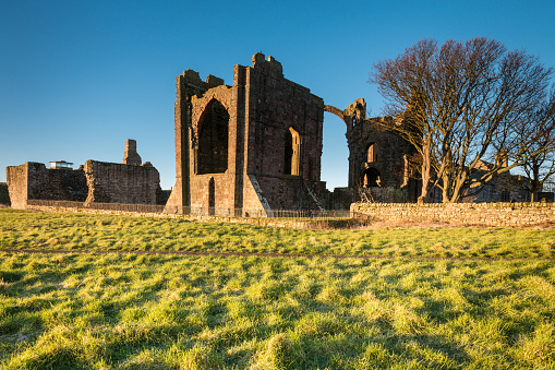 The ruins of Lindisfarne Priory on a sunny day at Holy Island