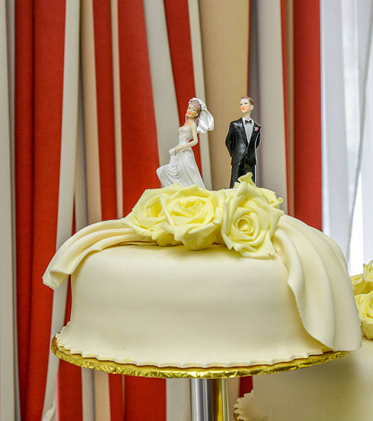 istock white wedding cake with yellow roses 514927766