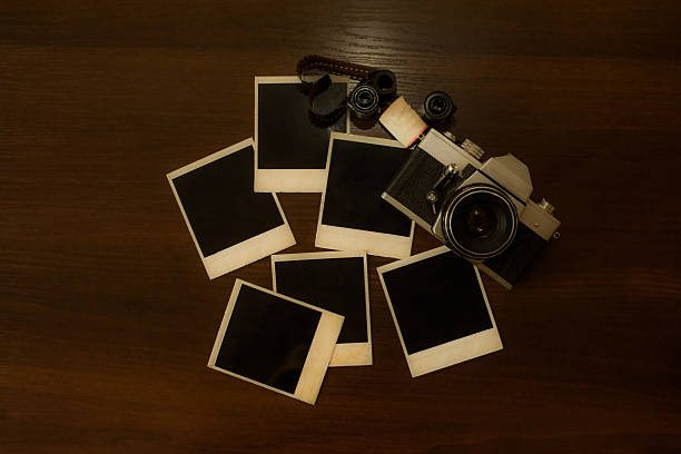 istock Old retro camera with photo frame on wood background 514928170