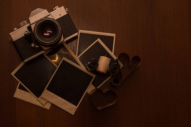 istock Old retro camera with photo frames on wood background 514929482