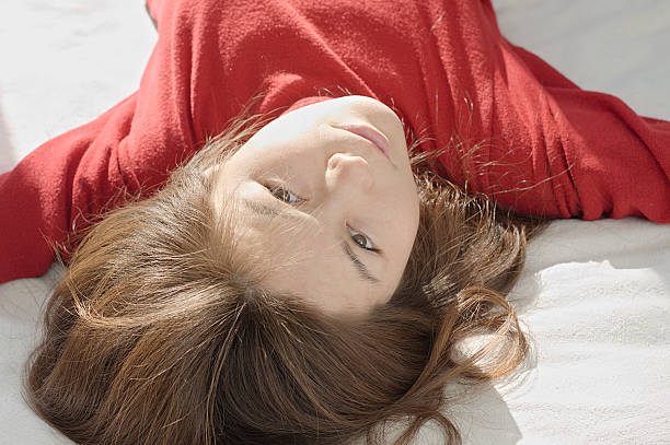 Asian woman upside down portrait  looking straight into the camera