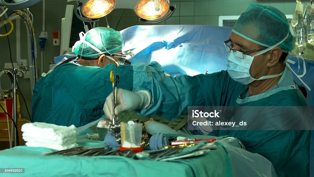 Two surgeons operating patient's heart Activity Stock Photo