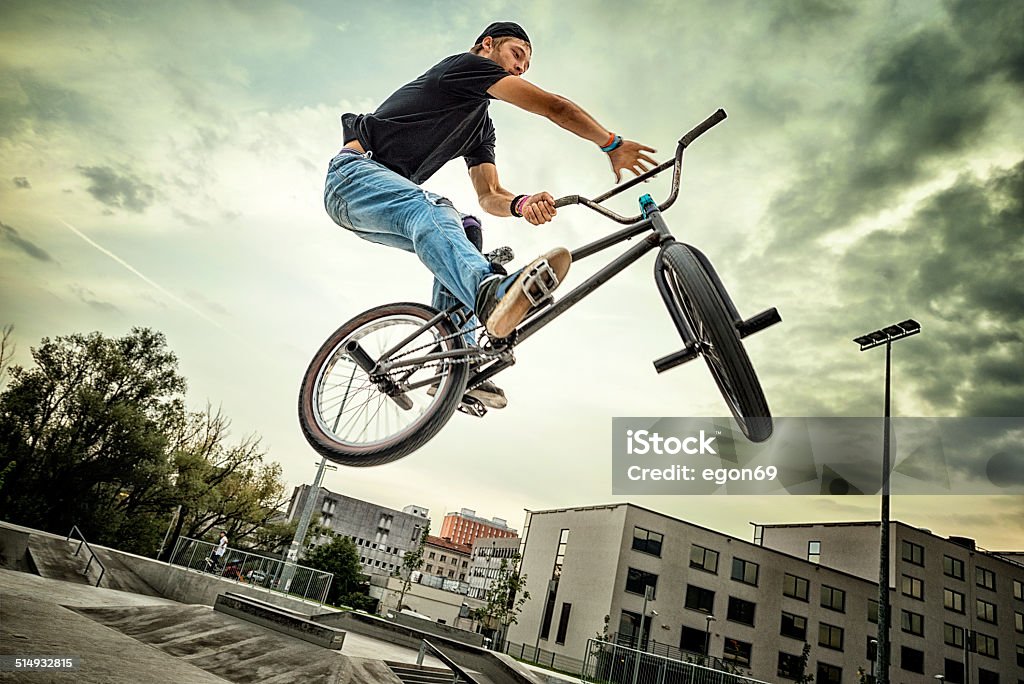 BMX biker BMX biker performing a stunt in ramp park. Freestyle BMX Stock Photo