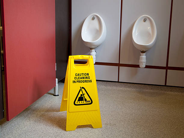 istock Cleaning in Progress Sign in Men's Urinal 514933386