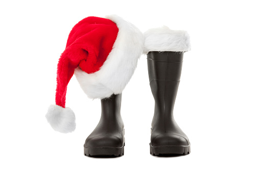 Santa's hat resting on his boots, isolated on a white background.