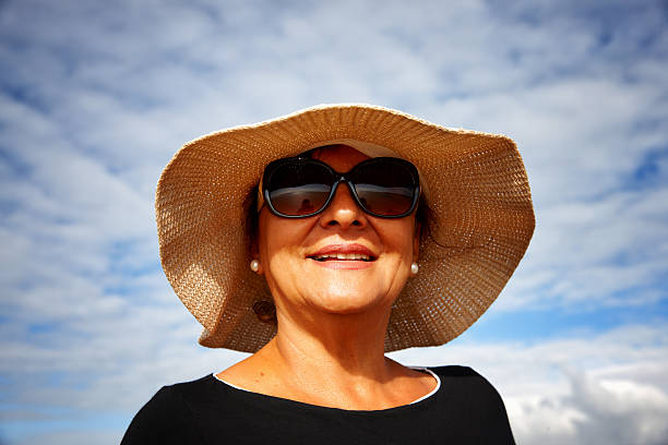 istock Mature smiling hispanic woman sunglasses and sunhat 514934345