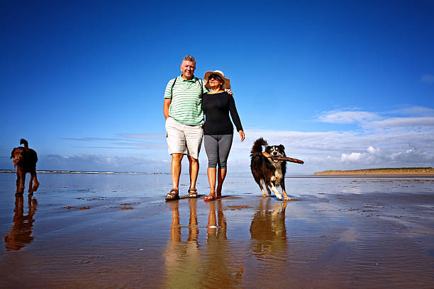 istock Mature smiling couple walking on the seashore 514934351