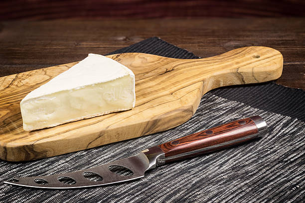 istock Cheese with white mold and cheese knife 514934634