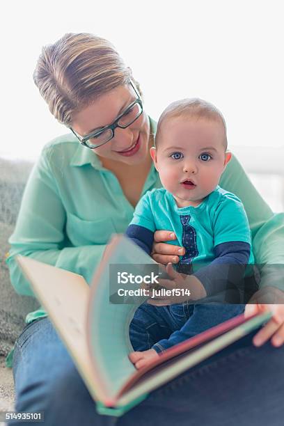 Cute Baby Reading With His Mother Stock Photo - Download Image Now - 6-11 Months, Adult, Book