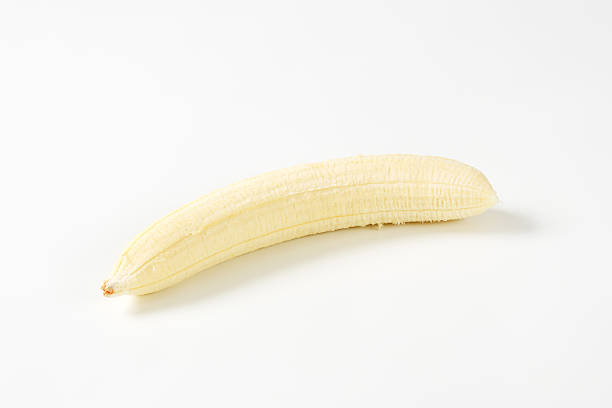 istock Peeled banana on white background 514935290