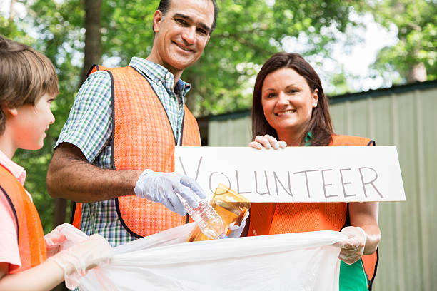 istock Volunteers: Family cleans up their community park. Teamwork. 514935804