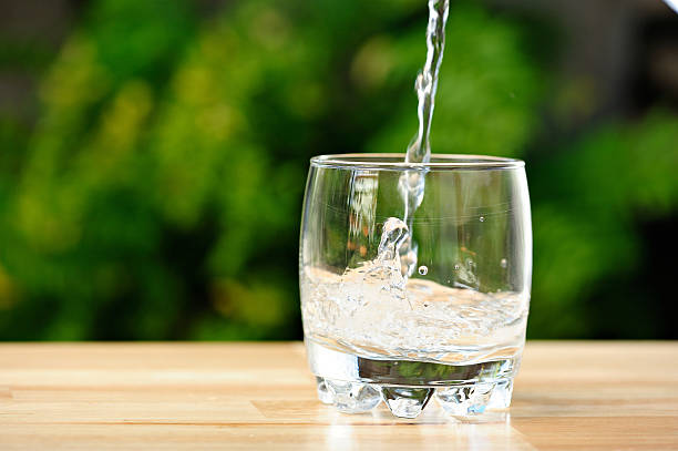 istock pouring water in whisky glass 514936260