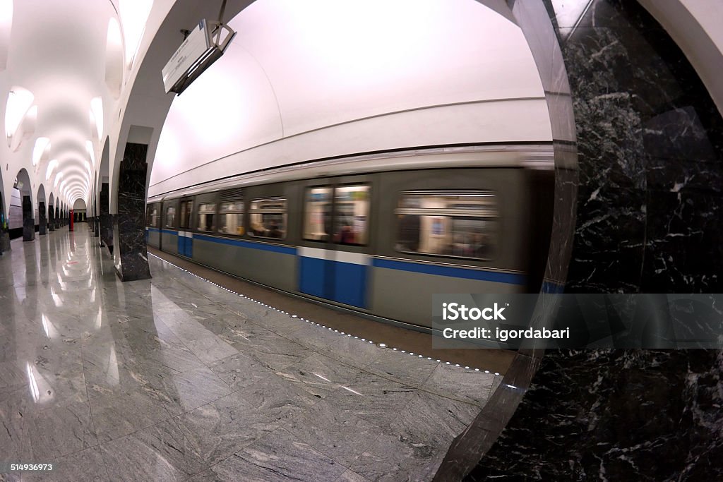 Subway station interior and train in motion An abstract transportation background: an interior of a subway station in Moscow (Russia) with arriving train which is in motion showing a blur effect. SHot with fish-eye lens. Architectural Column Stock Photo