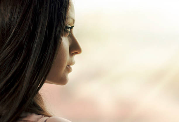 istock Woman standing at the window watching 514939090