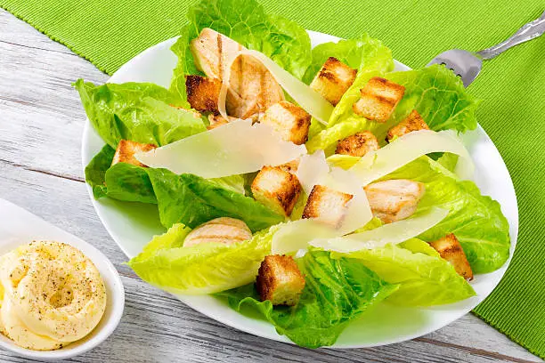 Caesarsalad with lettuce, croutons and grilled chicken breast, close-up