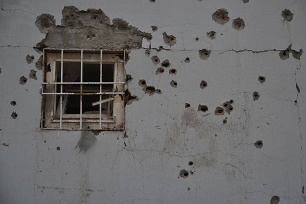 Bullet Holes on wall with a Window stock photo