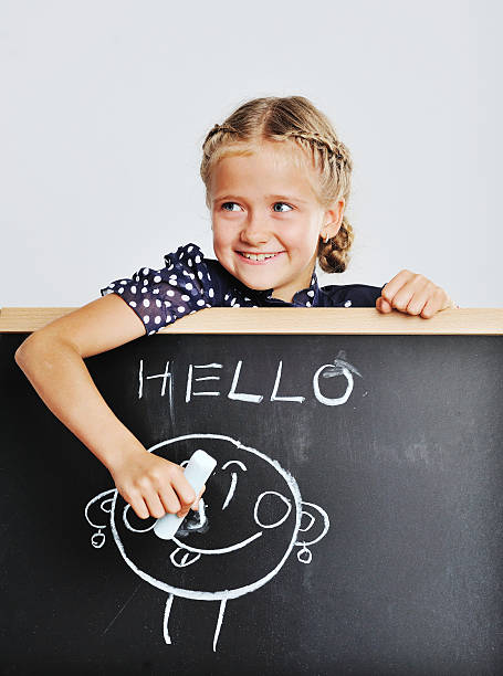 istock Smiling cute school girl drawing. 514960197