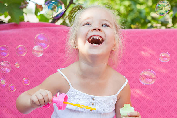 istock Happy little girl with soap bubbles 514961261