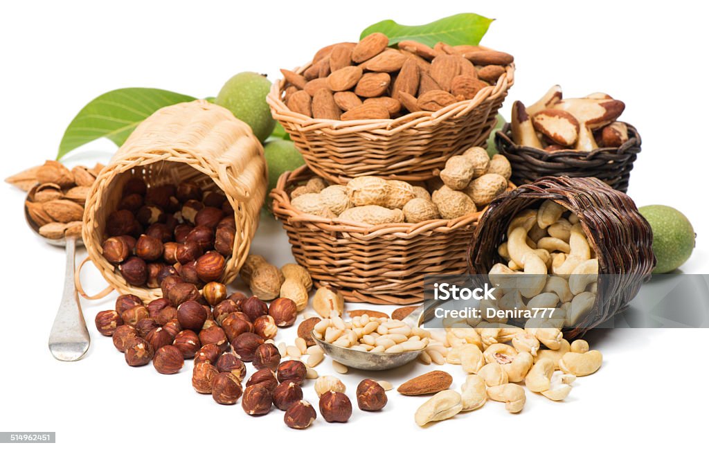 Different nuts Variety  nuts  (shelled and in their shells)  including almonds, cashew, hazelnuts, brazil nuts, peanuts, green walnuts with leaves and pine nuts.  Isolated on white background Almond Stock Photo