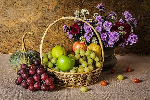 Still Life with Fruit baskets are arranged with a beautiful vase of flowers.