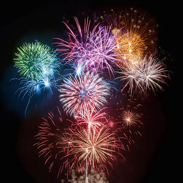 Colorful firework display, isolated on black background.