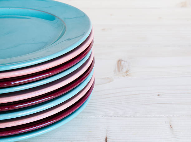 istock Colorful plates on a wooden background 514967945