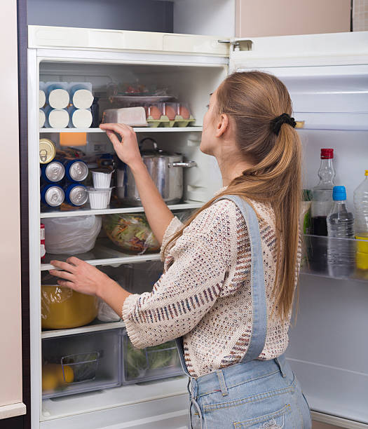 istock Housewife arranging products in fridge 514981902