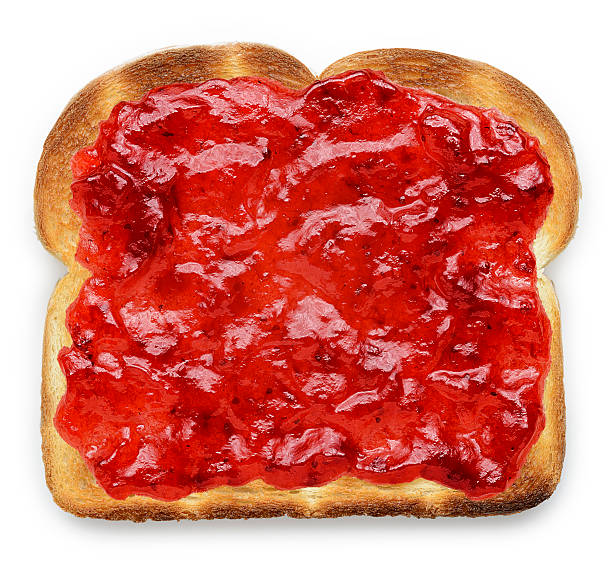Toast with Jam Slice of toasted bread with strawberry jam.  jam stock pictures, royalty-free photos & images