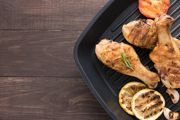 istock Grilled chicken drumstick and vegetables in a pan 514986856