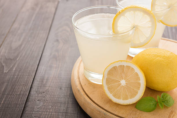 istock lemonade with fresh slice lemon on wooden table 514987446