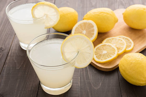 istock lemonade with fresh slice lemon on wooden table 514987790