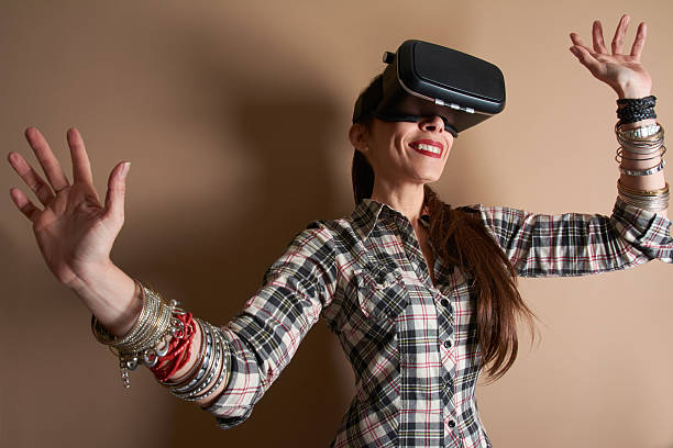 istock Woman in virtual reality helmet. hands enjoying the experience. 514988154