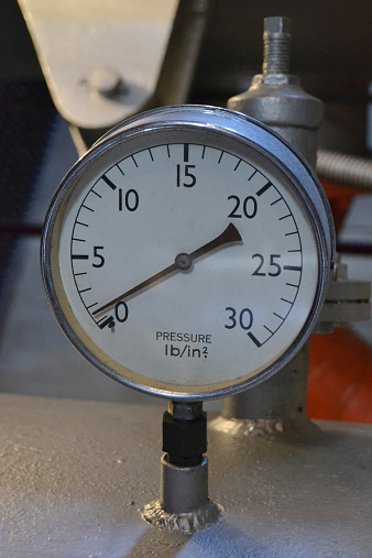 industrial pressure gauge (manometer) on heavy metal part