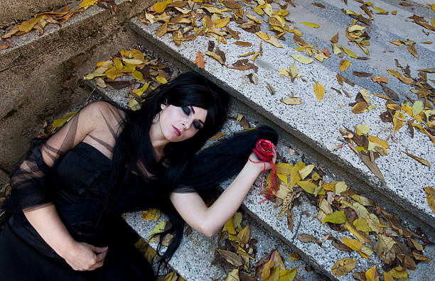 Young goth couple outdoors. Camera top view.