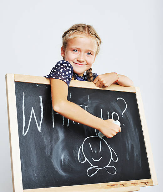istock Smiling cute school girl drawing. 514989513
