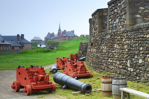 Old cannons and fortifications in Fortress of Louisbourg, Nova Scotia, Canada