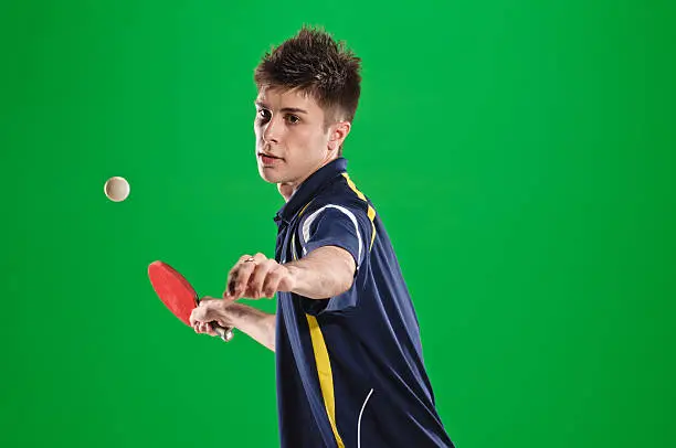 young man tennis-player in play on chroma key