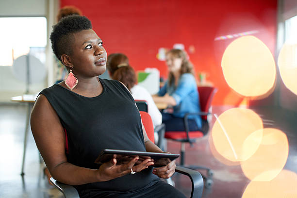 istock Confident female designer working on a digital tablet in red 514991874