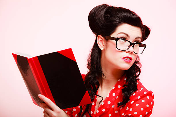 istock Retro. Pinup girl in eyeglasses reading book 514992455