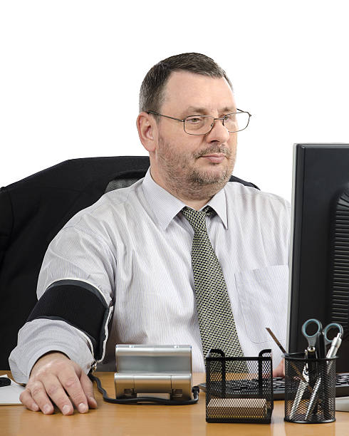 istock Glasses man measures blood pressure during virtual doctor visit 514993102