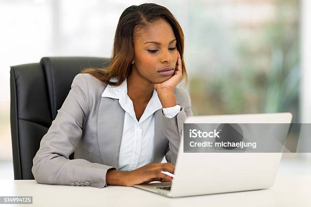 Young African Businesswoman Looking At The Laptop Screen Stock Photo - Download Image Now