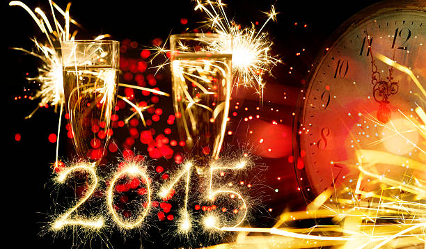 istock Champagne Glasses Infront Of Fireworks With Sparkling 2015 And Clock 514995109