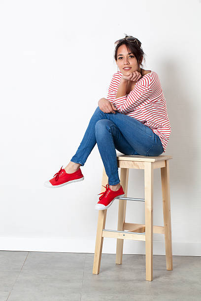 istock radiant young multi-ethnic female student sitting on a stool relaxing 514997216