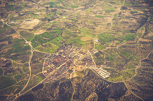 Little village in the middle of the countryside seen from above. The road connections show it like a spider web.