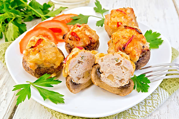 istock Champignons stuffed meat cut in white plate on light board 515000560